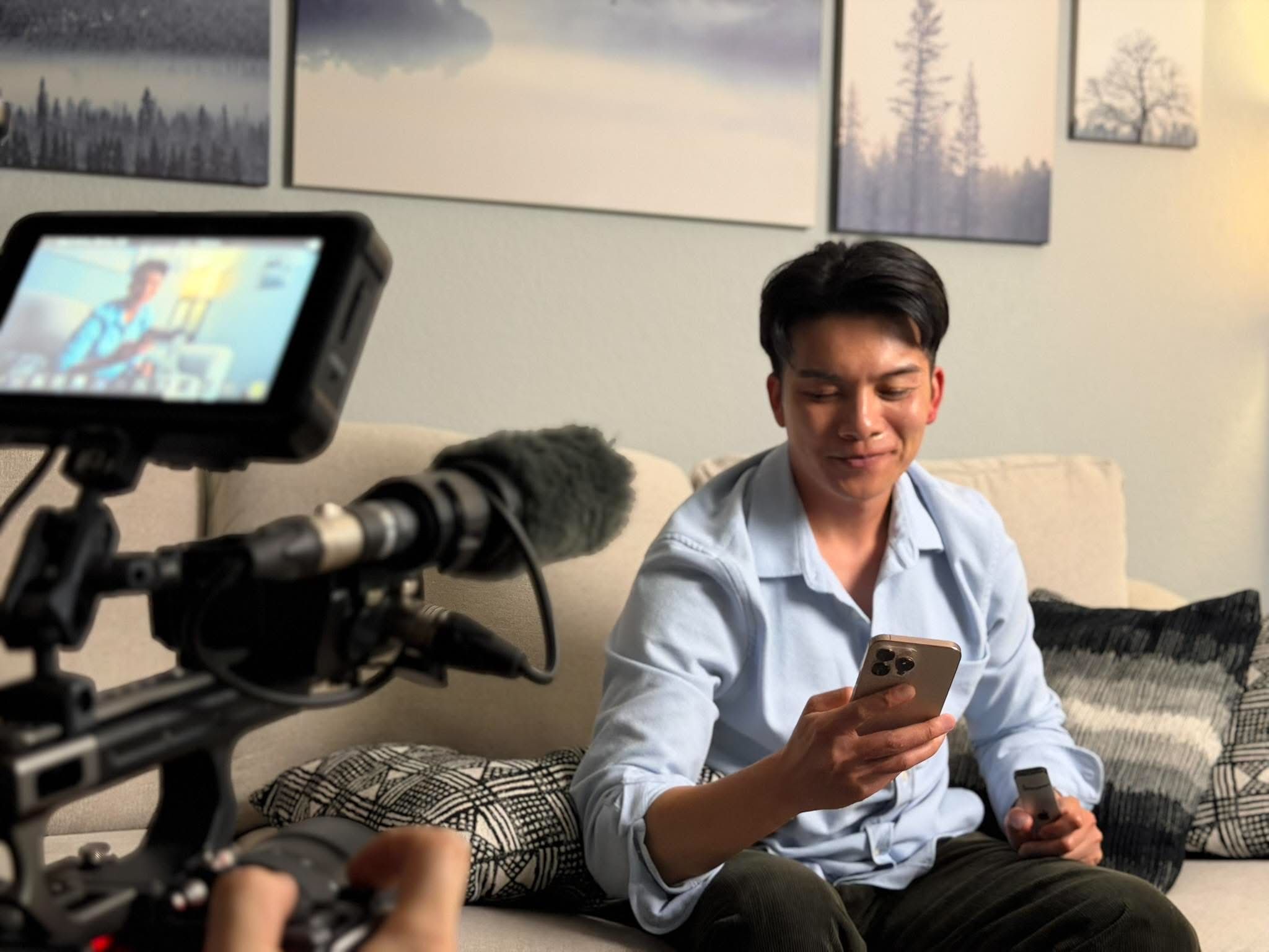 Thomas Tran in character on the couch, camera and monitor rolling