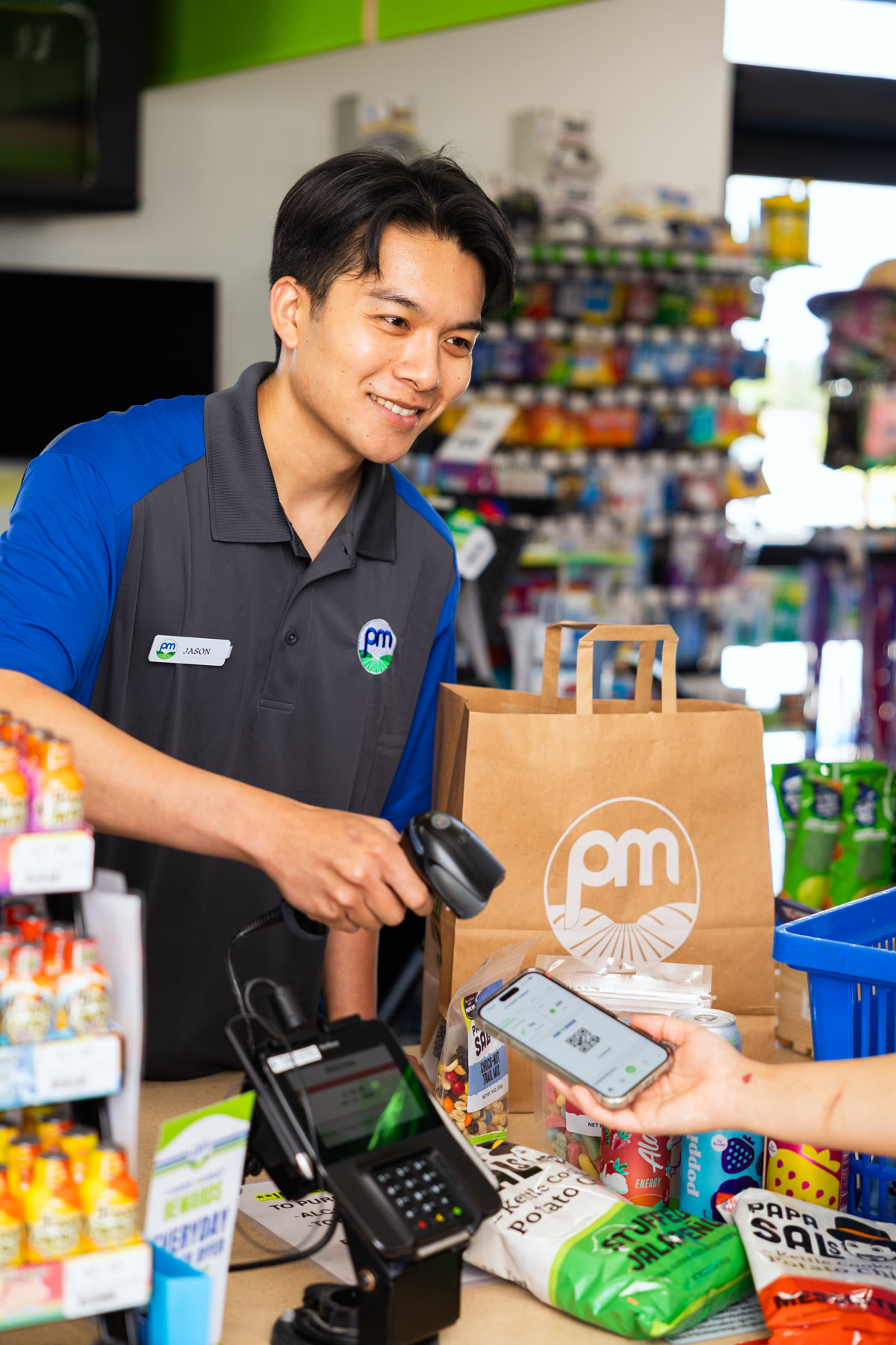 Thomas Tran working at a PowerMarket checkout counter