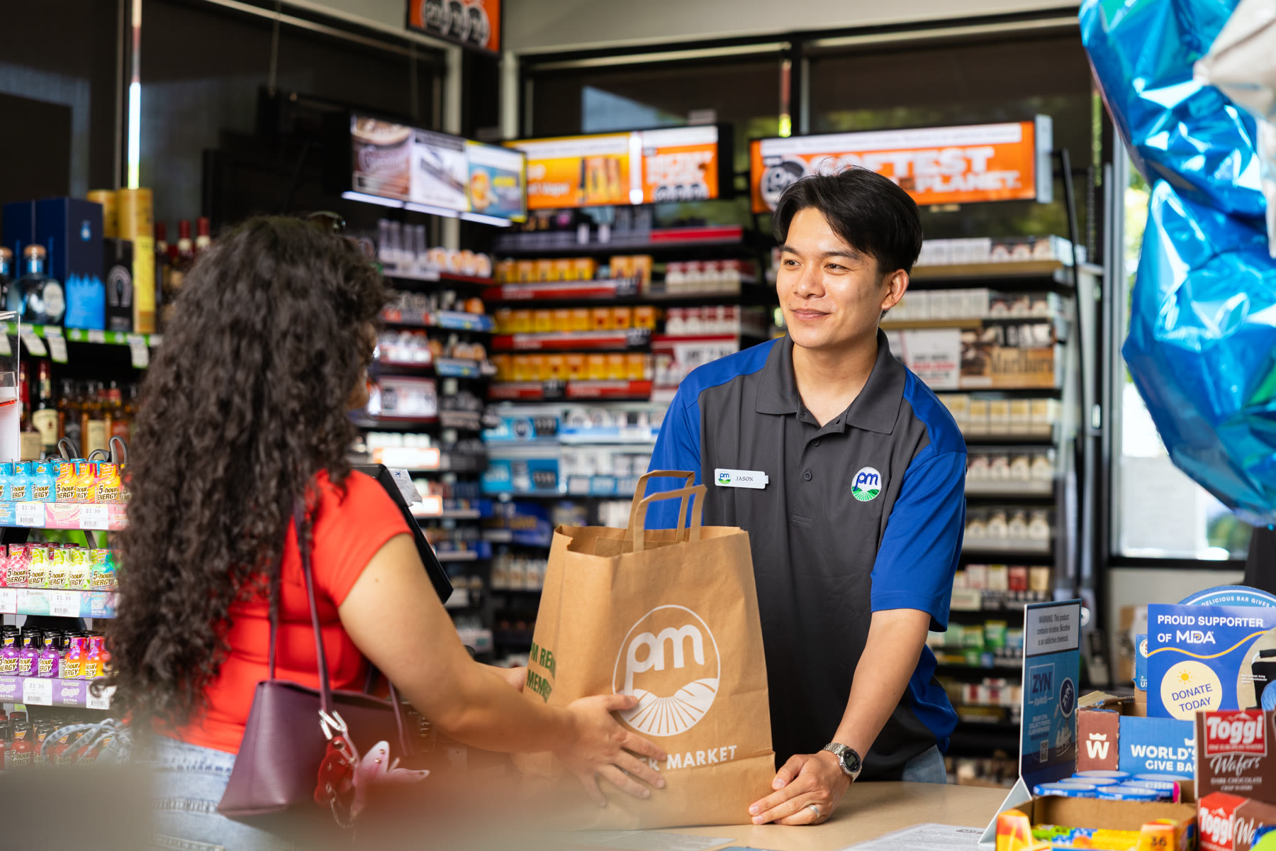 Thomas Tran assisting a customer at the checkout