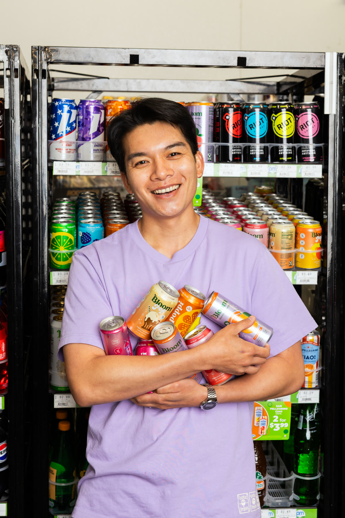 Thomas Tran holding drinks in a PowerMarket campaign photo