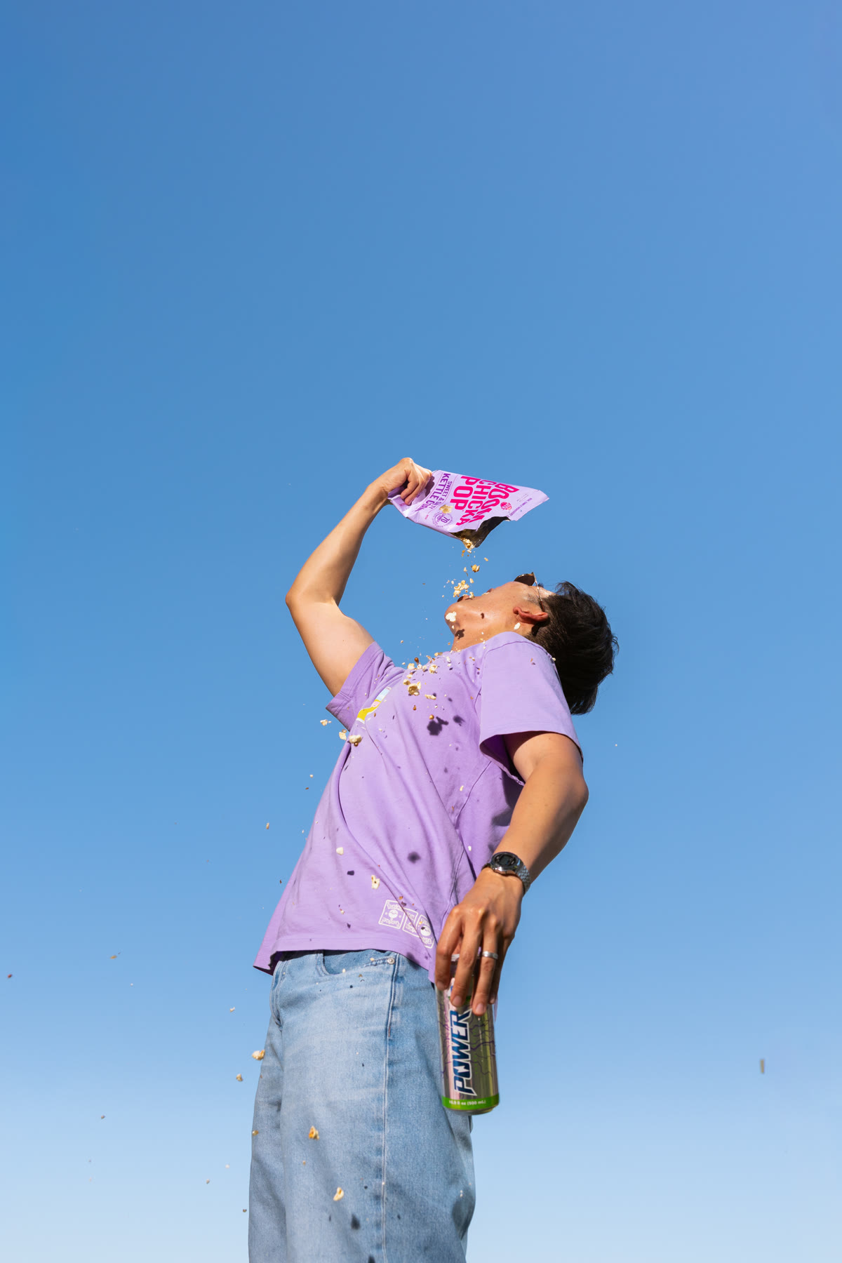 Thomas Tran holding products against a blue sky